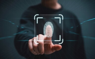 Futuristic biometric fingerprint scan glowing on a transparent digital screen, cyber security authentication concept