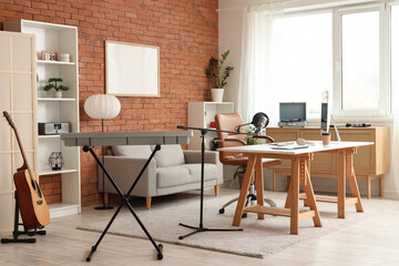 Interior of recording studio with workplace, sofa and musical instruments