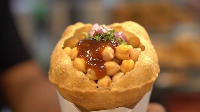 Close up Pakistani gol gappa filled chickpeas tamarind cinematic UHD handheld South Asian street snack stock video. savory pakistani puchka legume tamarindo movie ultra high