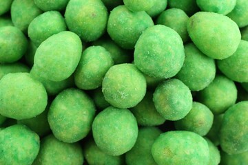 Tasty wasabi coated peanuts as background, closeup