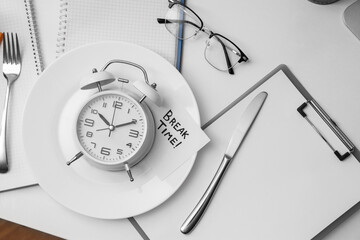 Paper with text BREAK TIME, alarm clock and table setting on desk in office, top view
