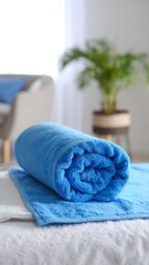 Rolled blue blanket on a bed