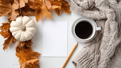 Flat lay featuring a blank card, autumnal elements, and a warm drink