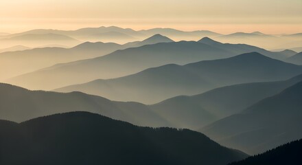 Obraz premium Layers of Mountains at Sunrise, A Hazy and Serene Landscape