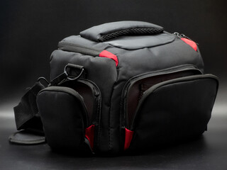 Generic black and red camera bag with shoulder strap, camera bag concept