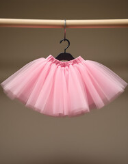 Delicate Pink Tulle Tutu Skirt Hanging on Wooden Hanger