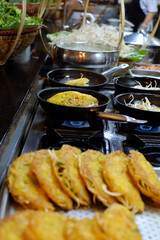 A chef is cooking Banh Xeo, a traditional Vietnamese food, at a resort buffet