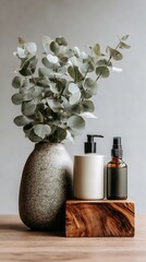 Eucalyptus vase with skincare bottles on wooden block