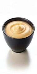 Cheese sauce in a black bowl isolated on white background
