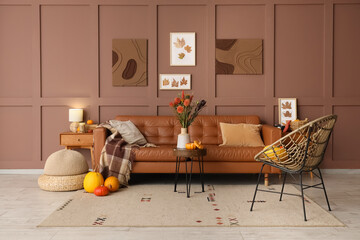Interior of cozy living room with sofa, tables and autumn decor