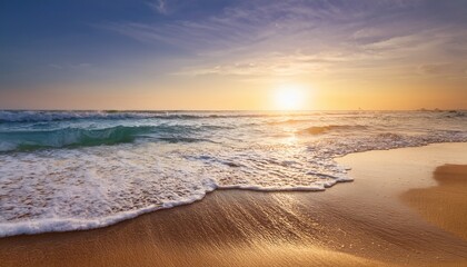 Obraz premium Serene Beach Background Soft Sand Tranquil Ocean Waves Gently Lapping The Shore At Sunrise Perfect For Travel Vacation Or Summer Themed Projects Nature Coastal Idyllic