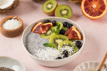 Healthy breakfast bowl with chia pudding, kiwi, blood orange, and berries