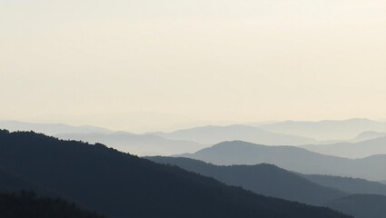 Fototapeta premium Serene mountain range landscape at dawn with soft pastel sky and misty valleys below