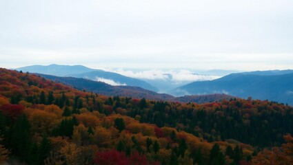 Fototapeta premium Misty mountain range at sunrise with foggy valleys and hazy horizons