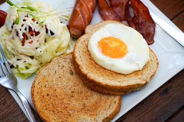 Closeup of Breakfast with Toast, Egg, Bacon, and Salad
