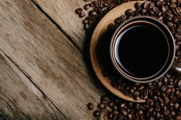 Aromatic black coffee in brown cup sits on saucer with roasted coffee beans, creating inviting scene on rustic wooden table