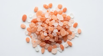 Pile of pink himalayan salt crystals isolated on a white background, closeup view