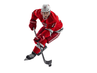 Focused hockey player in motion with powerful stance and poised stick handling ready for action on