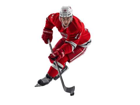 Focused hockey player in motion with powerful stance and poised stick handling ready for action on