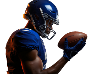 Focused American football player gazes intently at ball in hand isolated view