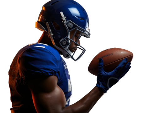Focused American football player gazes intently at ball in hand isolated view