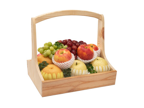 A variety of fruits are beautifully arranged in a pine wood basket isolated on white background