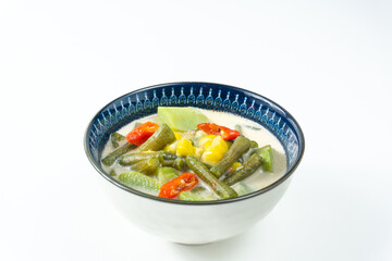 Sayur lodeh or vegetable soup cooked with coconut milk, delicious of traditional Indonesia Indonesian food.  Consist of chayote, long beans, and corn. Served in bowl, top view