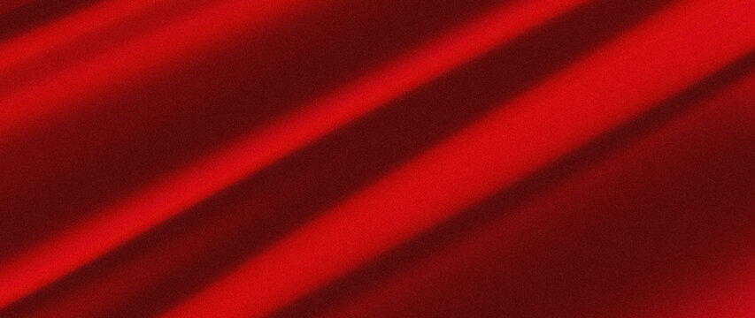 Abstract red background with diagonal light streaks creating a dynamic pattern