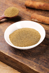 Ground Cumin Spice Powder in Bowl on Wooden Board - Aromatic Seasoning Ingredient for Cooking and Barbecue