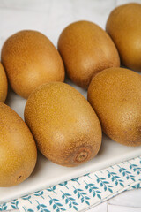 Fresh Golden Kiwi Fruits from New Zealand on White Background with Shallow Depth of Field