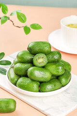 Fresh Green Mini Kiwi Fruits in Bowl with Tea Cup - Healthy Organic Snack Food Photography