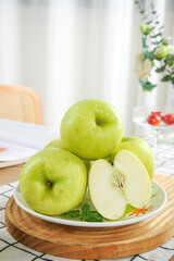 Fresh Green Apples with Water Droplets on White Plate and Wooden Tray