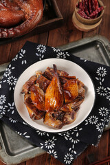 Gourmet Smoked Duck Glazed Meat Pieces in Bowl on Rustic Wooden Table for New Years Eve Celebration