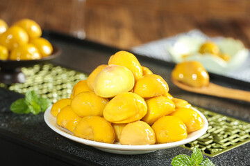 Freshly cooked glazed chestnuts on plate with mint garnish - traditional alpine fruit cuisine