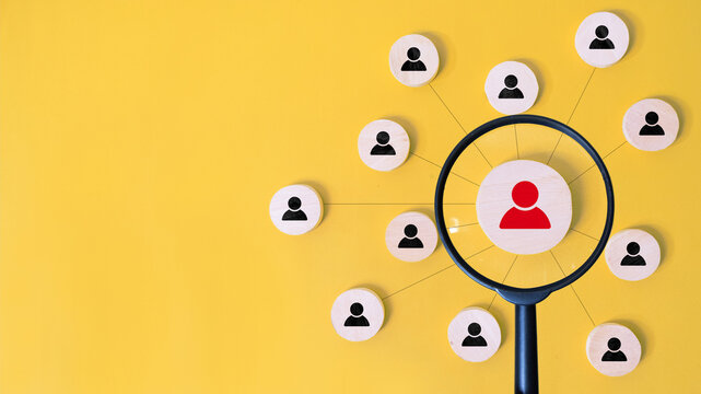 R human resources management concept. magnifying glass focuses on manager icon on wooden block with connection link network for organisation structure. employment headhunting, candidate