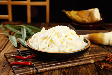 Fresh Bamboo Shoots in Lacquer Bowl - Traditional Asian Cooking Ingredient on Wooden Background