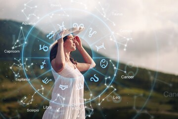 Young female astrologer on nature background
