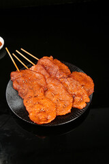 Grilled Meat Skewers with Caramelized Glaze on Dark Plate - Restaurant Style BBQ Food