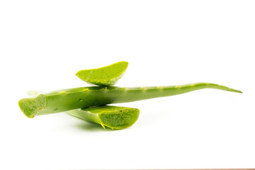 Fresh aloe vera slices stacked on white background for skincare and health use