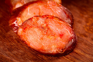 Homemade Sichuan Smoked Sausage Slices - Traditional Chinese Spicy Cured Meat on Wooden Board