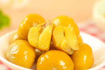 Fresh Raw Chestnuts with Open Shells Showing Golden Kernels in Bowl