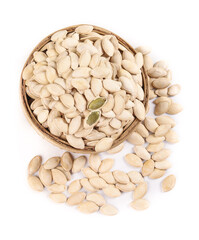 Raw pumpkin seeds in wooden bowl isolated on white background - healthy cooking ingredient