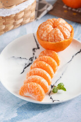 Fresh Seedless Tangerine Segments on Marble Plate with Mint Garnish