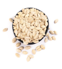 Dried pumpkin seeds in black bowl on white background - healthy snack food pepitas