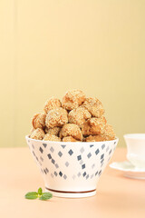 Crispy Sesame Seed Balls Chinese Dessert Specialty Guangxi Traditional Sweet Snack in Decorative Bowl