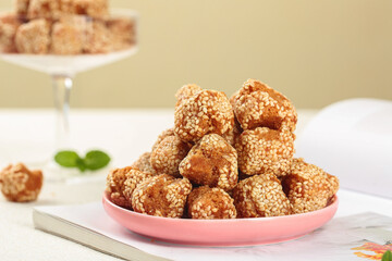 Traditional Guangxi Sesame Seed Balls - Chinese Sweet Crispy Snacks on Pink Plate