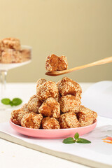 Traditional Asian Sesame Seed Balls Fried Pastry Dessert on Pink Plate with Mint Garnish