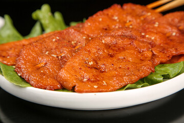 Grilled Marinated Meat Slices with Fresh Lettuce on White Plate - BBQ Cuisine