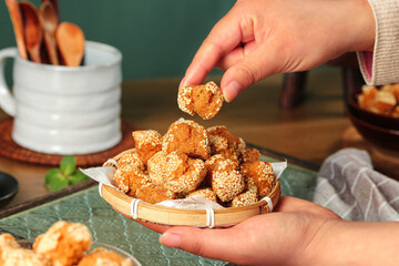 Traditional Guangxi Sesame Ball Pastries - Chinese Hemp Seed Specialty Sweets in Bamboo Basket