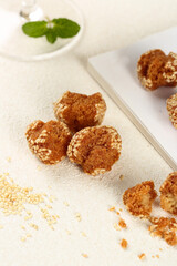Traditional Chinese Sesame Balls Crispy Pastries with Mint Garnish on Parchment Paper
